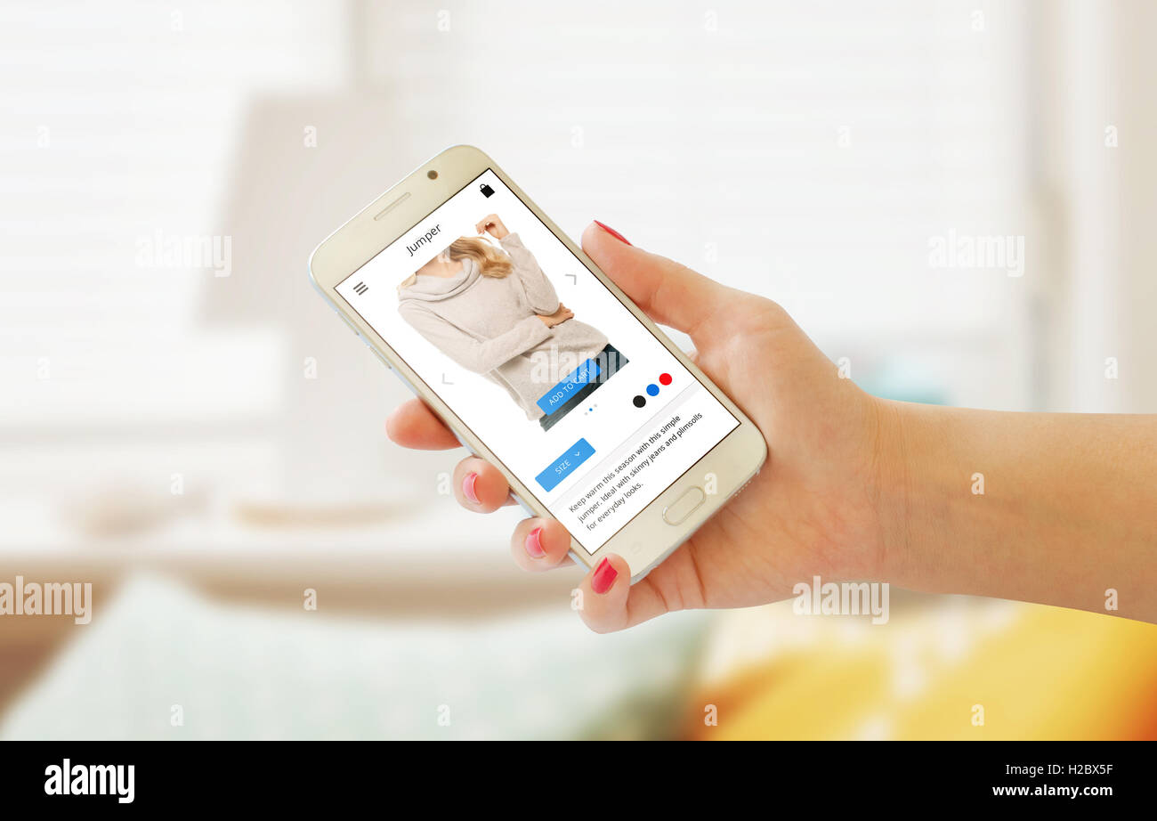 Online-shopping mit Smartphone in der Hand der Frau. Website oder app auf dem Handydisplay. Innenraum im Hintergrund. Stockfoto