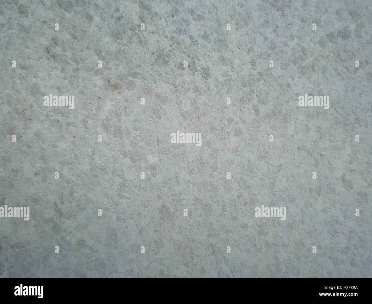 Ein Detail der Zement- und Steinmauer, Textur, Muster, helle Farben, monocrome Stockfoto