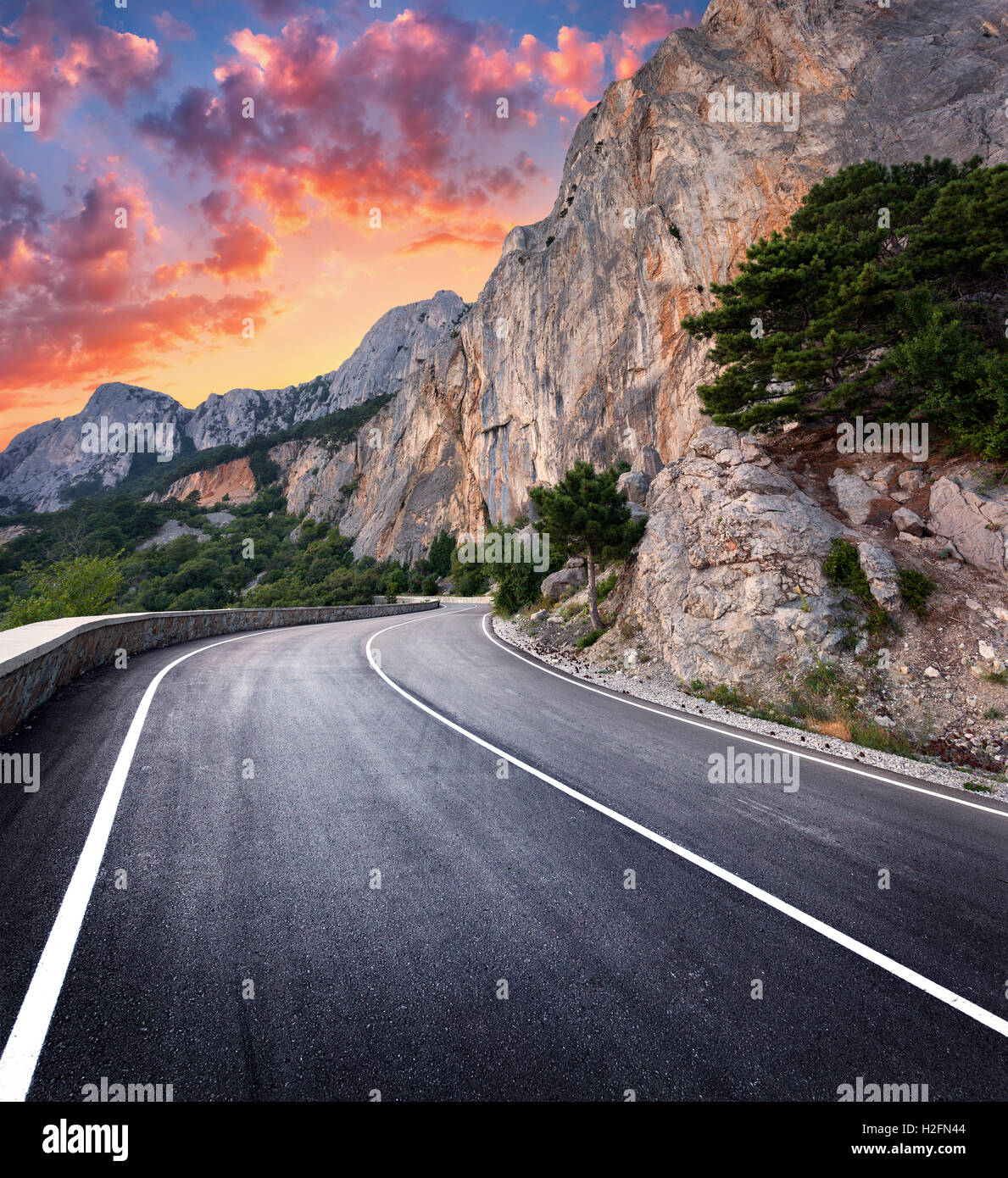 Asphaltierte Straße. Bunte Landschaft mit schönen kurvenreiche Bergstrasse mit perfekter Asphalt mit hohen Felsen, erstaunlich Himmel bei Sonne Stockfoto