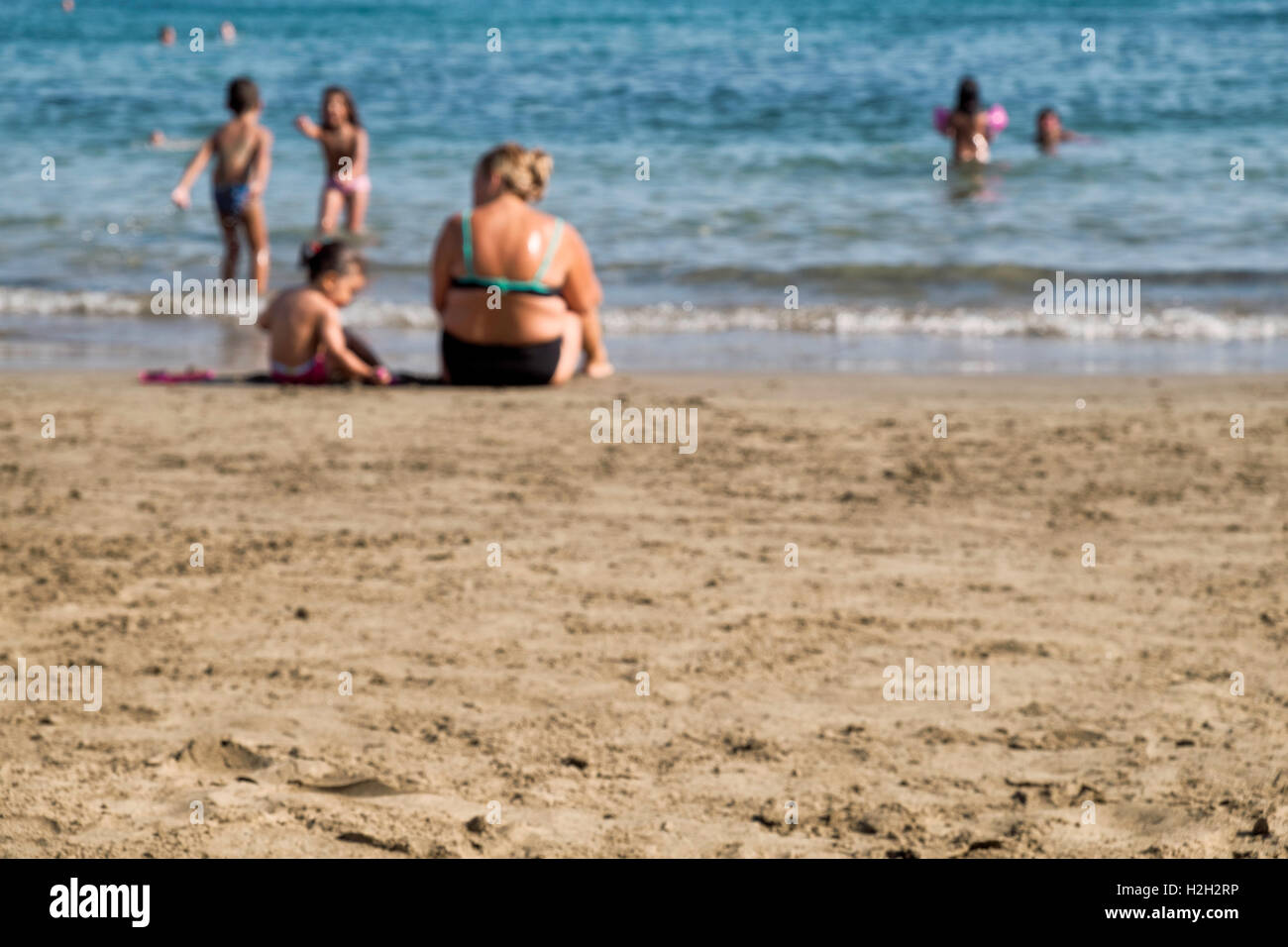 Absichtlich aus Fokus Bild aller Arten von Menschen, die Spaß am Strand Stockfoto