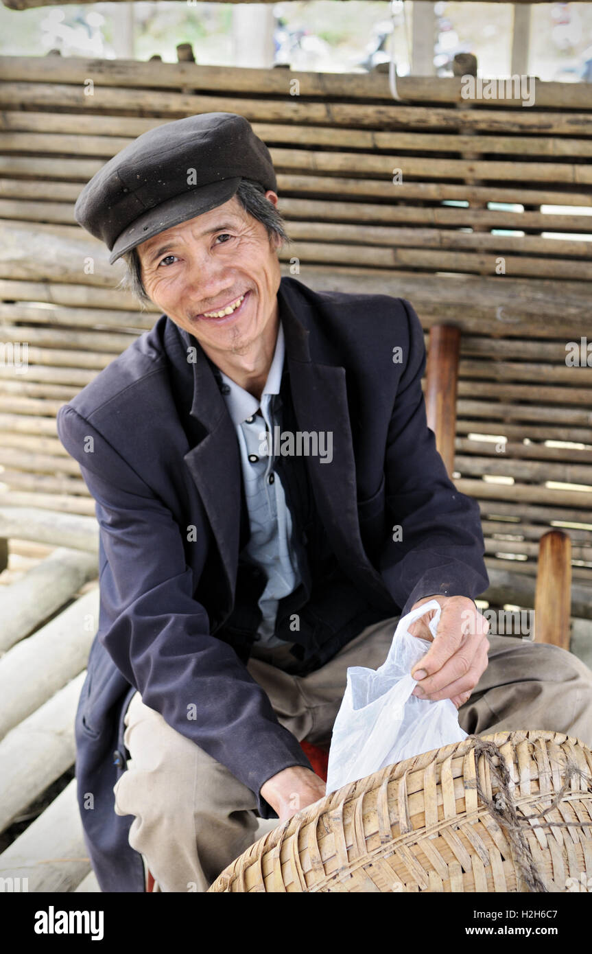 Porträt von ein lächelnder Mann trägt eine Mütze auf dem Quyet Tien-Markt in Ha Giang Provinz, Nord-Vietnam Stockfoto