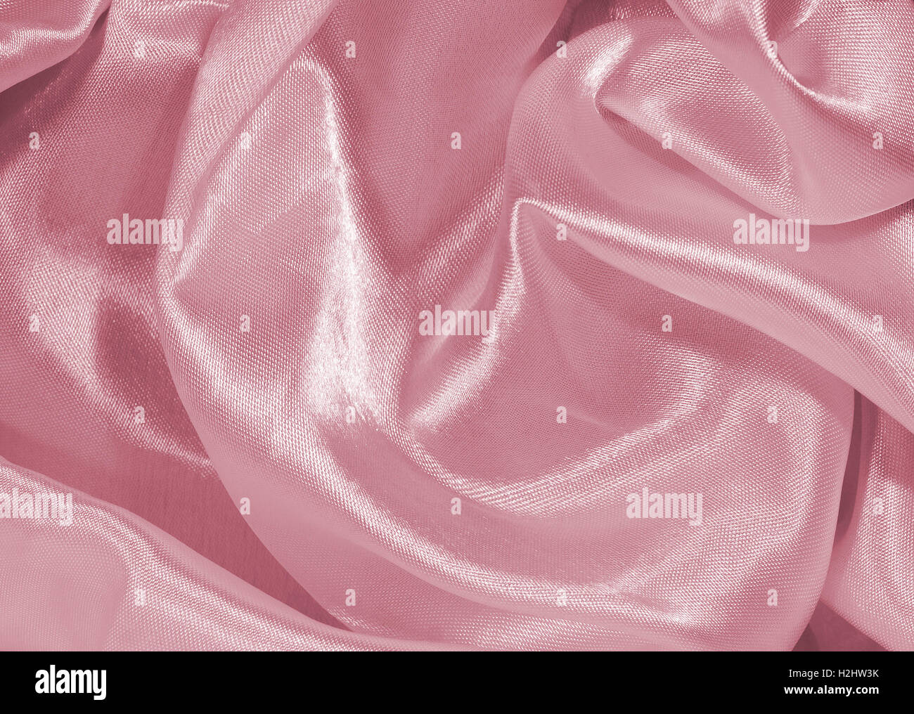 Abstrakter Hintergrund aus synthetischen / Seide Textile Textur / Muster in rosa. Stockfoto