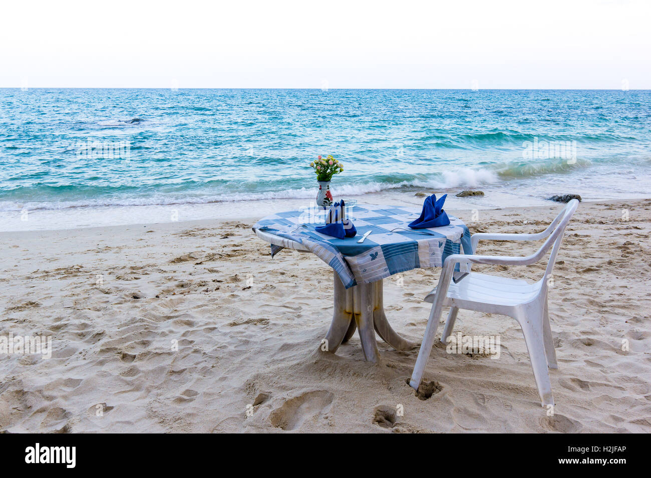 Tischdecke auf dem Tisch in der Nähe das türkisfarbene Meer zu verwischen Stockfoto