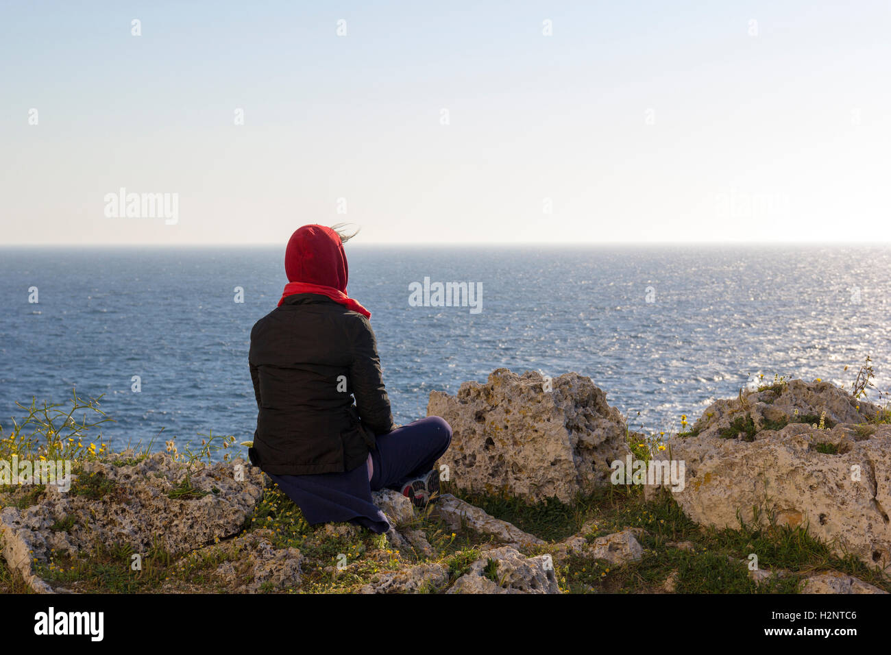 Frau in der Meditation auf der Klippe Stockfoto