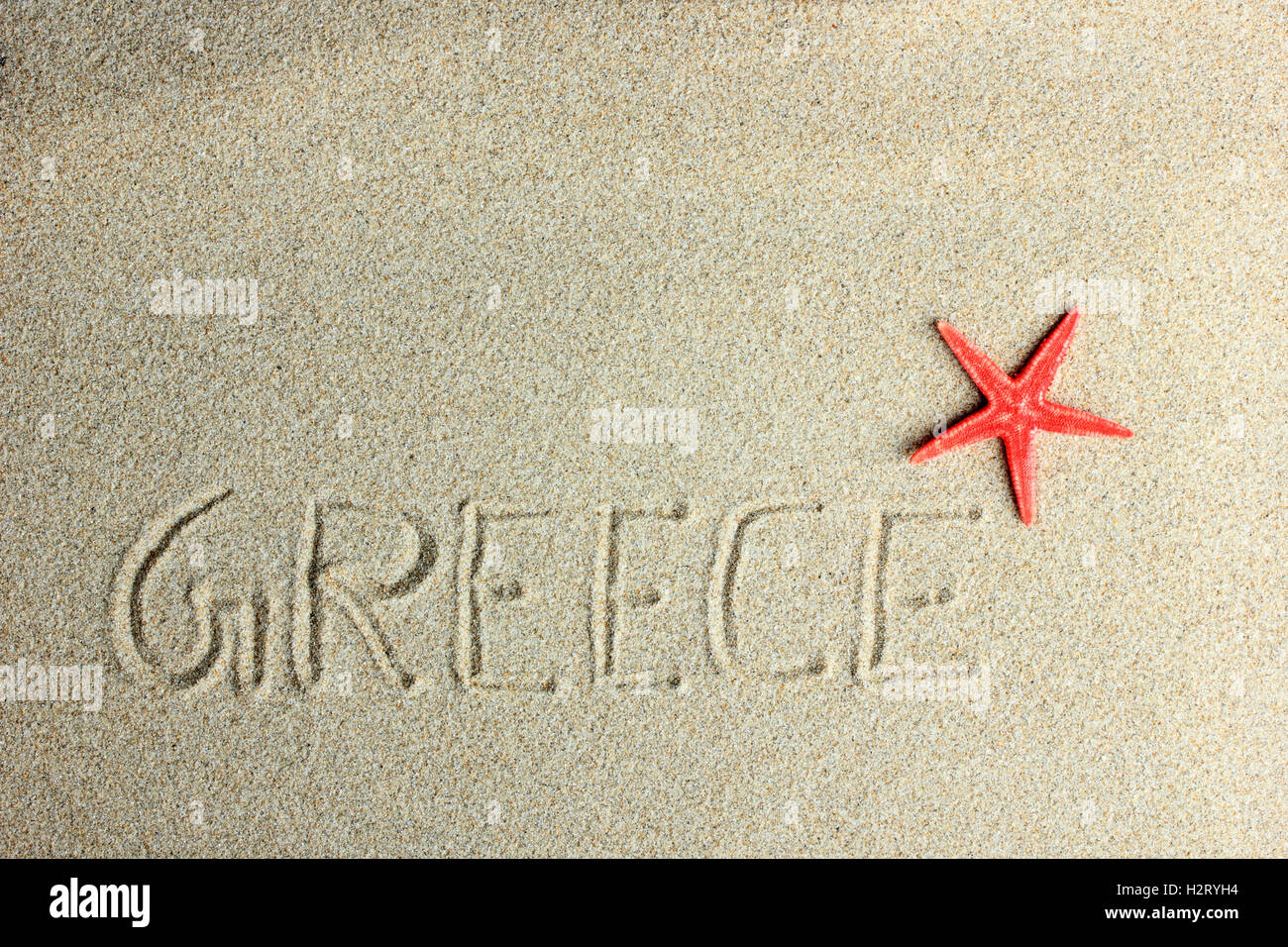 Griechenland in den Sand und roter Seestern am Strand geschrieben Stockfoto