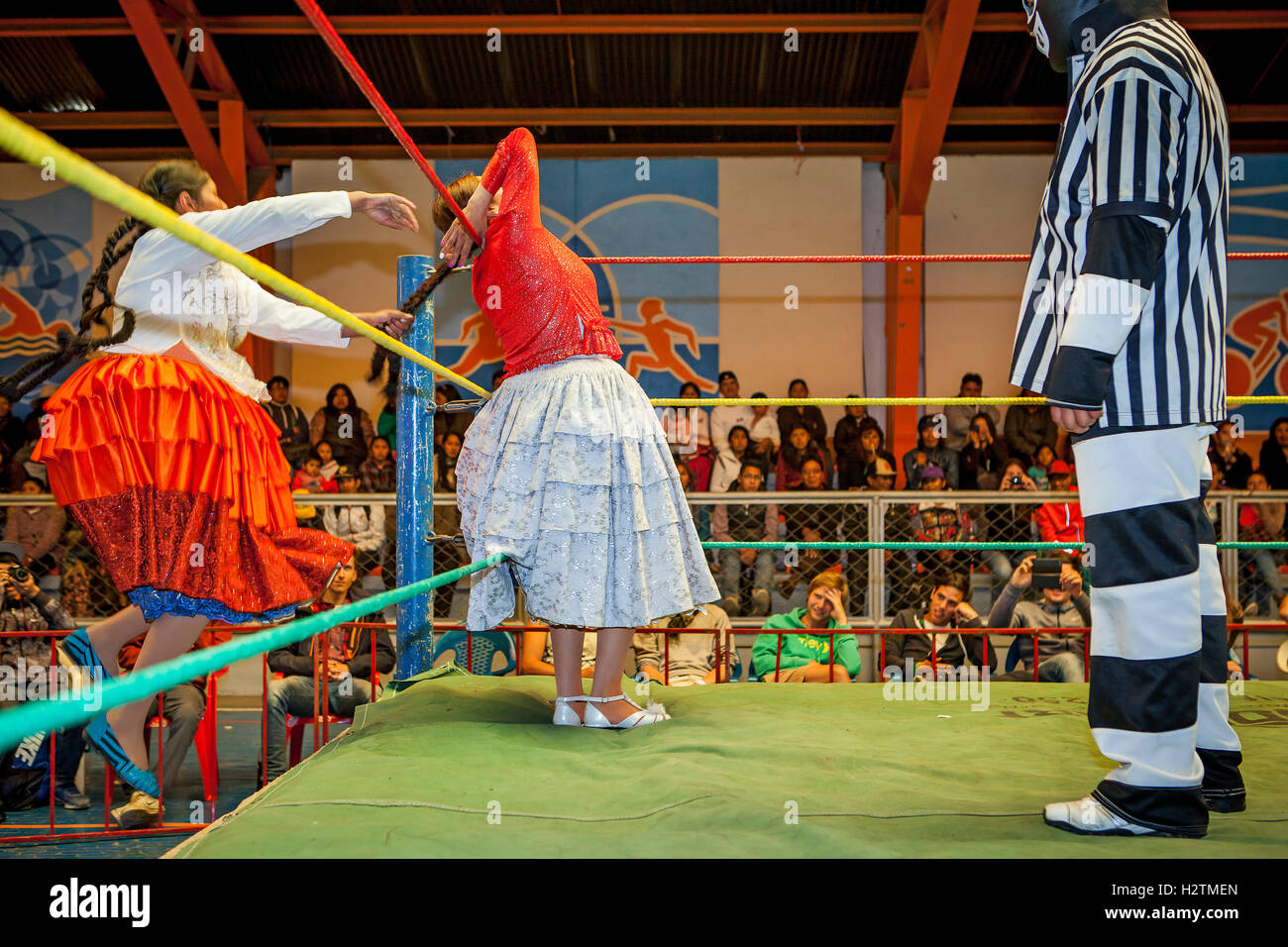 Lucha Libre. Kampf zwischen Dina mit orangefarbenen Rock und Benita la Intocable, Cholitas Weibchen Ringer, Schiedsrichter, Sport ce Stockfoto