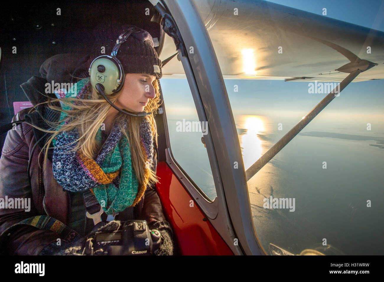 Mädchen auf dem Rücksitz eines Flugzeug fliegen über Tanger Insel in Virginia. Stockfoto