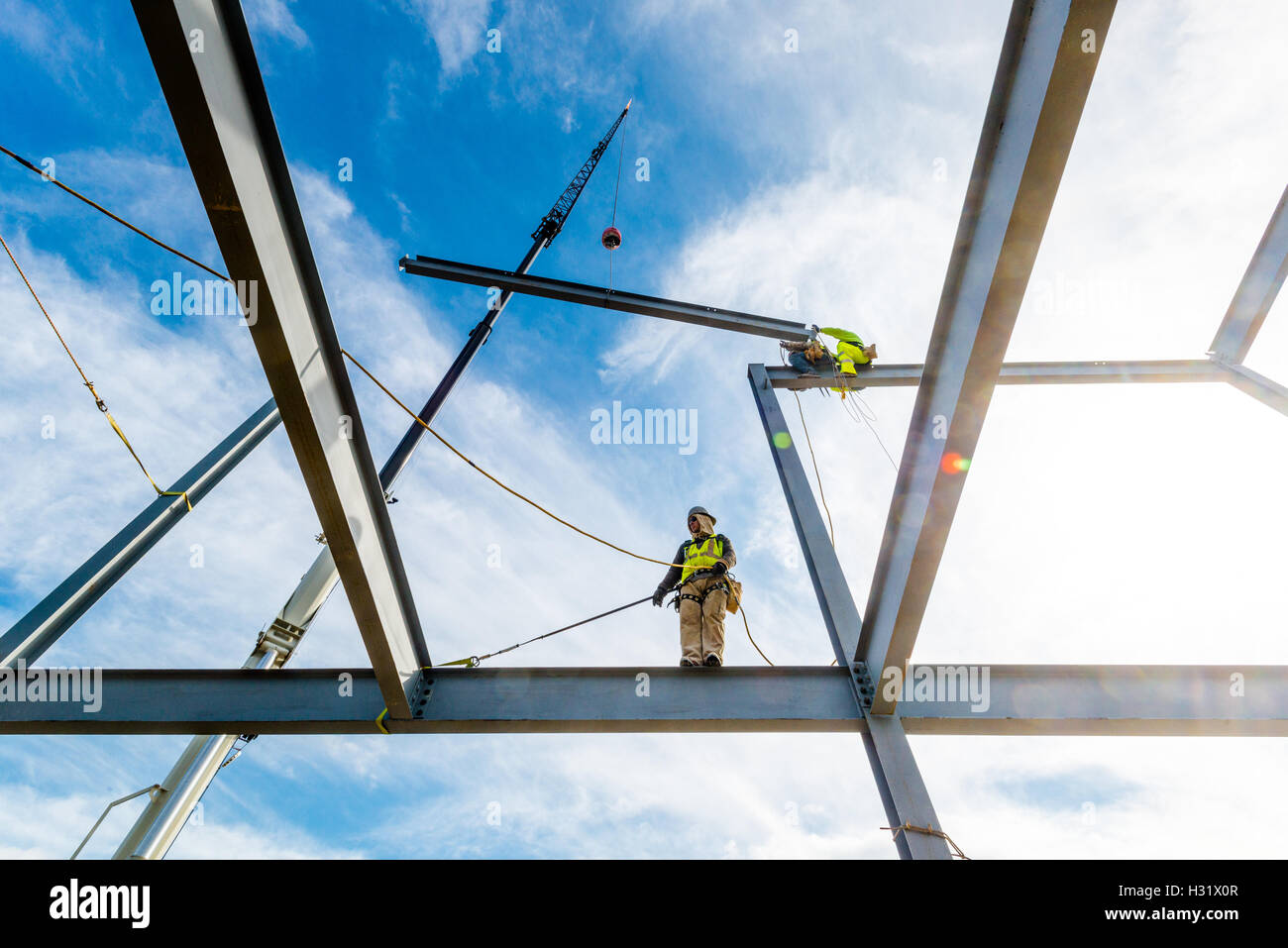 Eisen Arbeiter sitzt auf einem Balken auf einer Baustelle Stockfoto