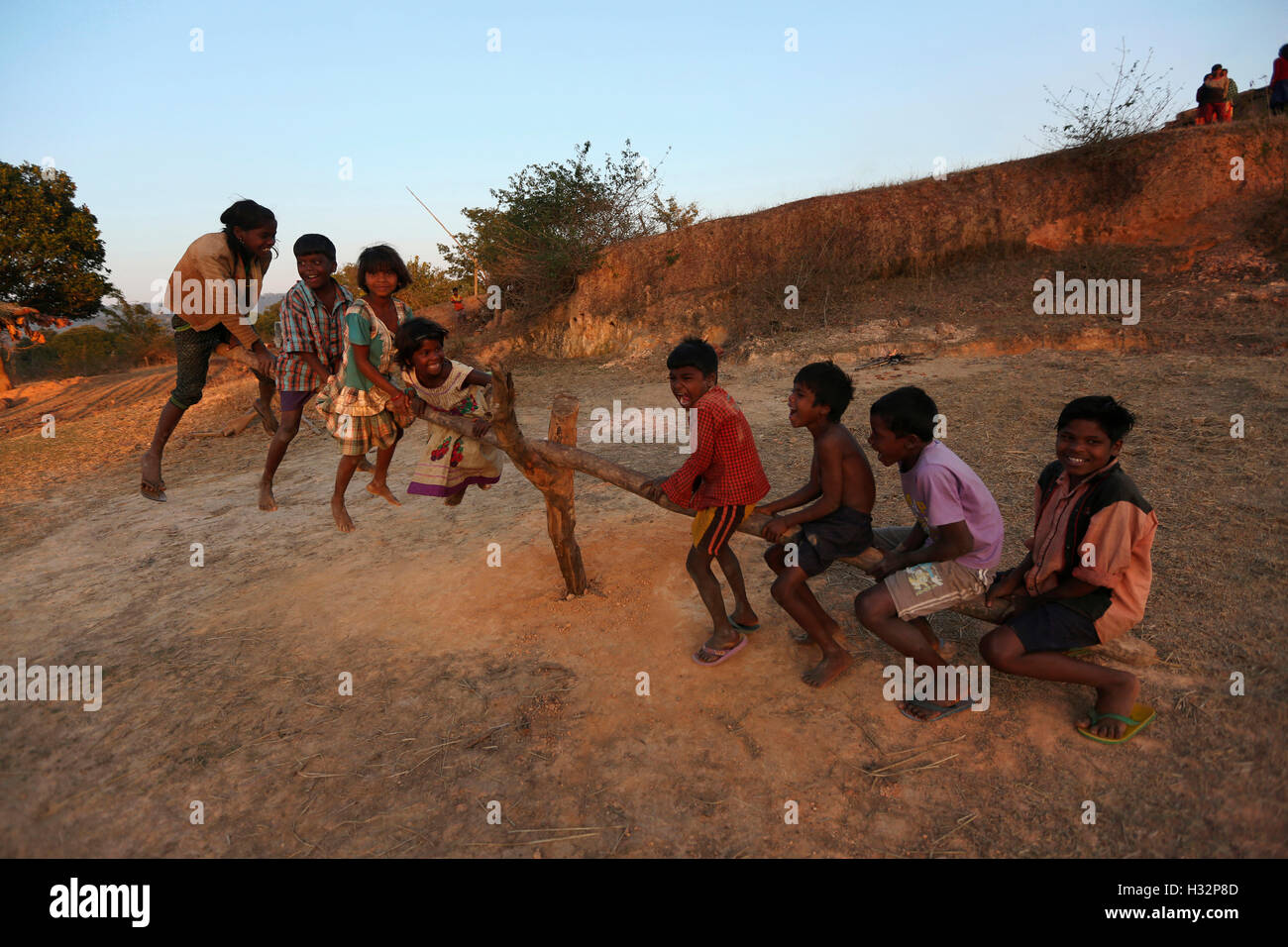 Kinder spielen auf einer hölzernen Meer sah, ORAON Stamm, Balrampur Tehsil, Surguja Bezirk, Chattisgarh, Indien Stockfoto
