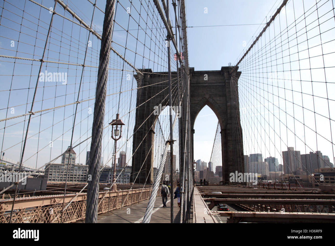 Ein weblike Muster von Stahl Tragseile der Brooklyn Bridge mit Neo-gotischen Brückenturm im Hintergrund. New York City, USA Stockfoto