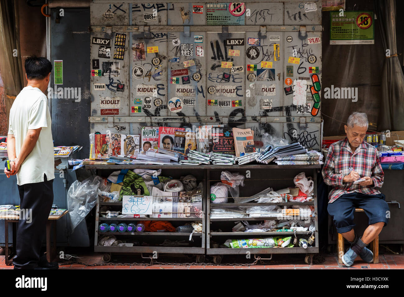 Alter Mann verkaufte Zeitungen und Zeitschriften in Sheung Wan auf Hong Kong Island in Hong Kong, China. Stockfoto