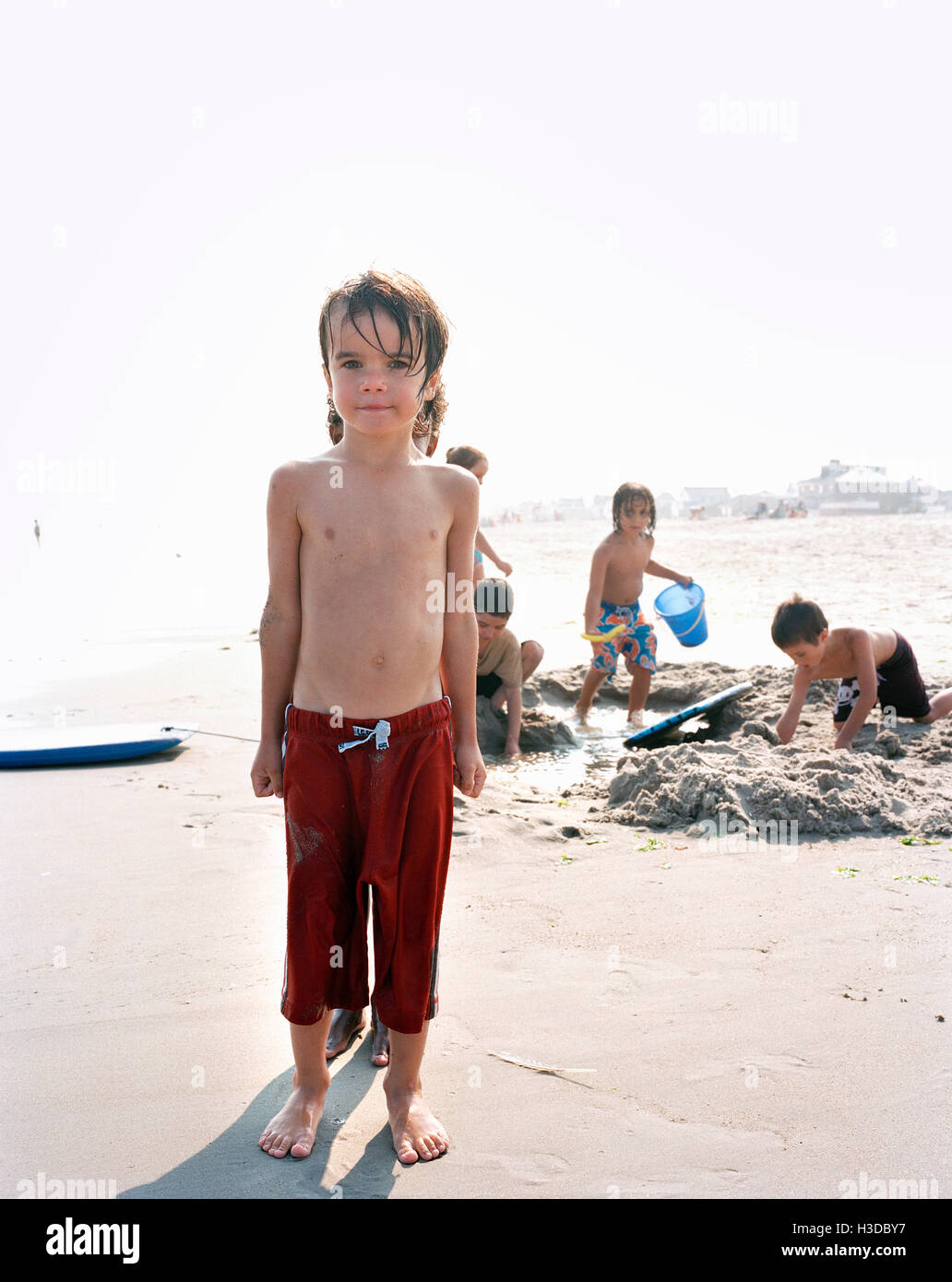 Gruppe von Jungs spielen an einem Sandstrand am Meer. Stockfoto
