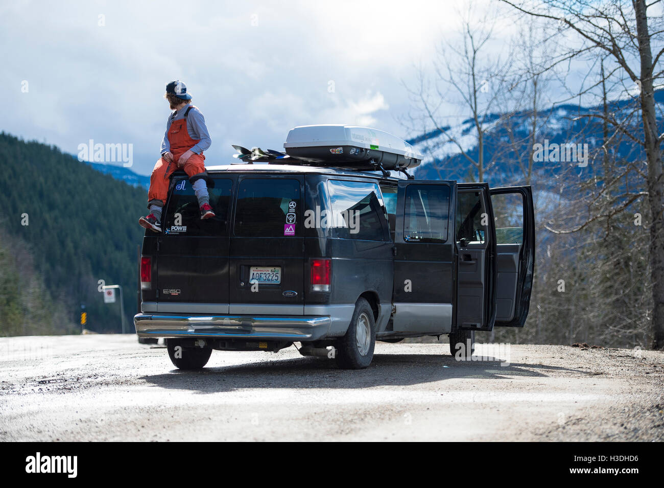 Ein Snowboarder sitting on Top of van Auschecken der Umgebung Stockfoto