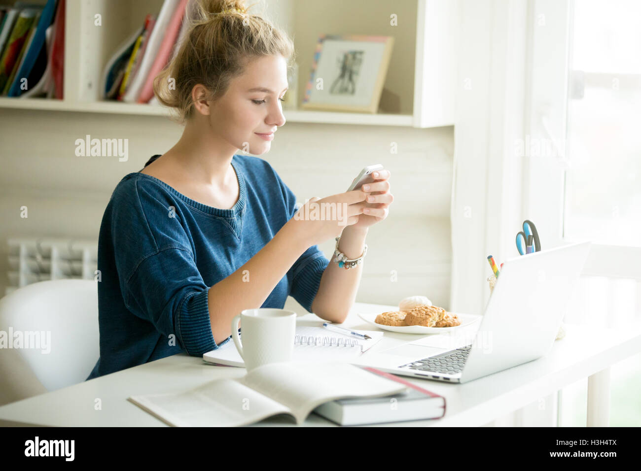 Glückliche Frau messaging im gemütlichen Heim-Büro Stockfoto