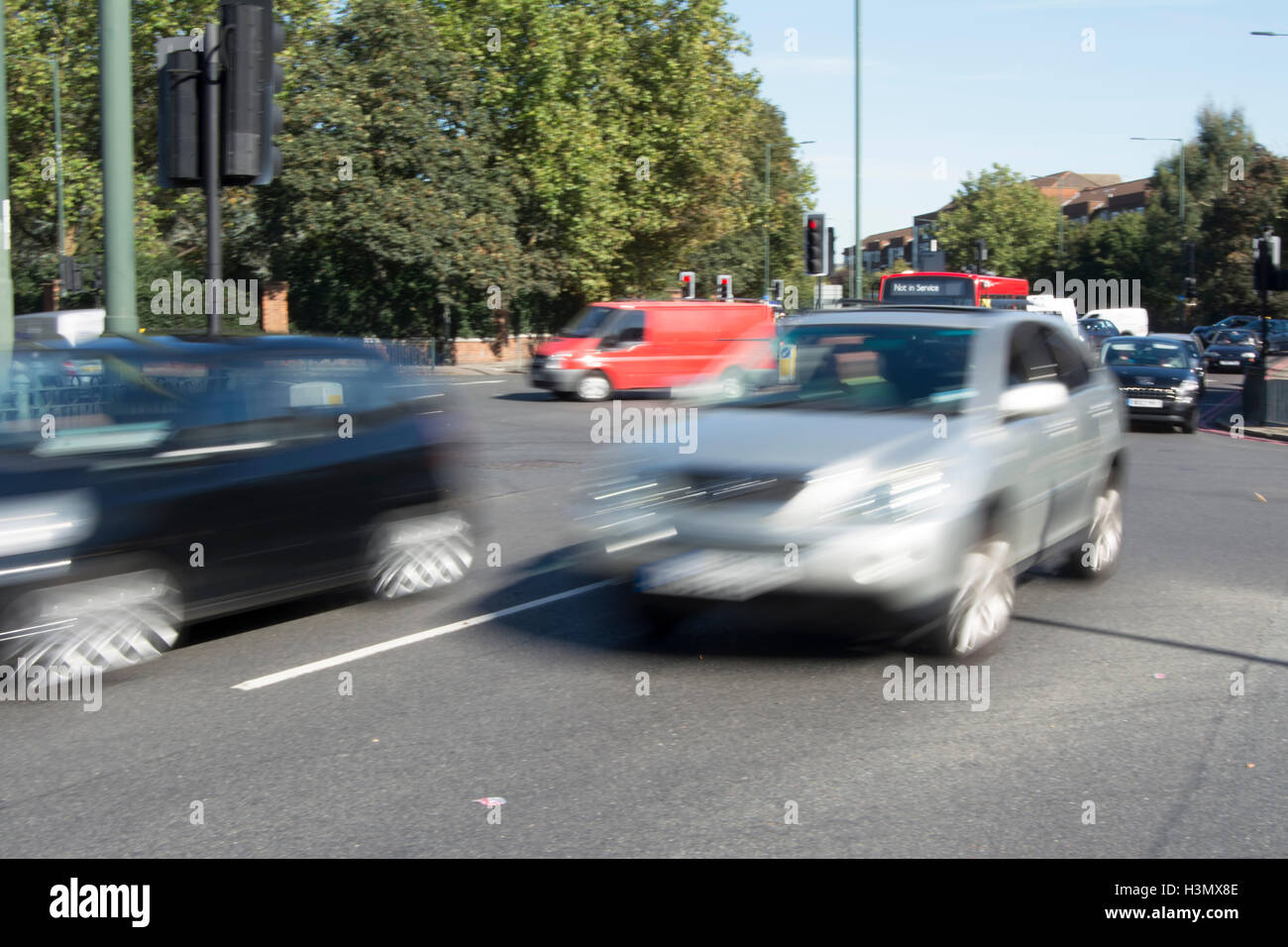 Fahrzeuge in Bewegungsunschärfe Kreuzung Chalkers Ecke, einer großen Straßenkreuzung in East Sheen, London, england Stockfoto