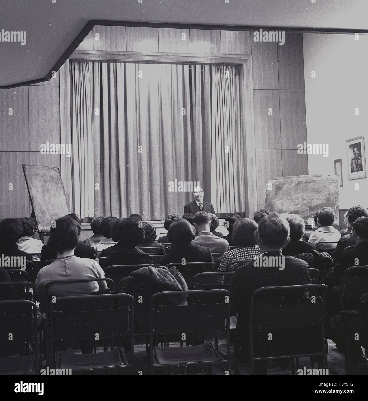 1960er-Jahren, historische, Mann sitzendem Publikum in der Halle einen Vortrag geben. Stockfoto