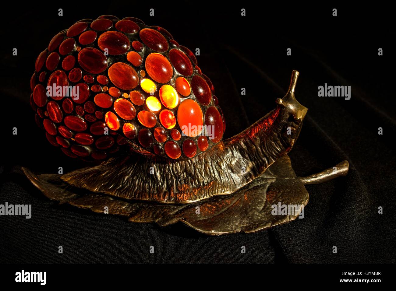 Handgefertigte Lampe in Form einer Schnecke aus Bronze und baltischen Naturbernstein gemacht Stockfoto