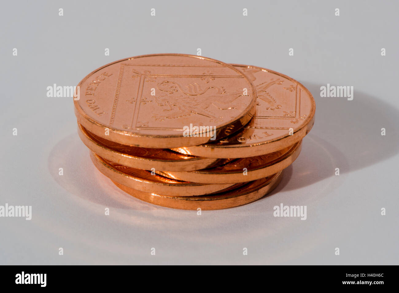 Stapel von sechs, glänzend, Kupfer, zwei Pence Münzen (insgesamt 12 Pence) gesehen Schwänzen sich - verlieren-Änderung, es hat Geld mit geringem Wert. Stockfoto