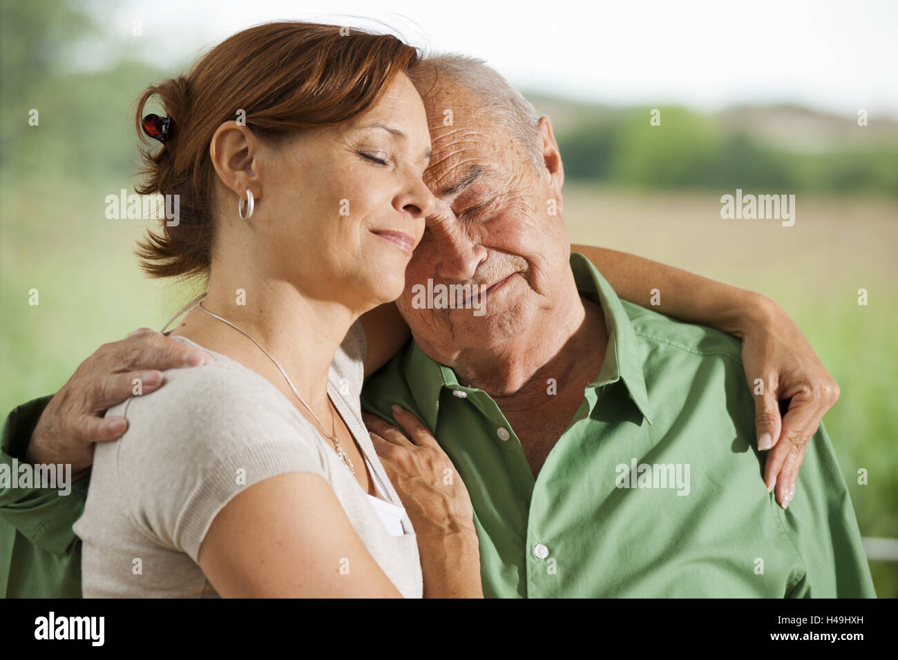 Tochter umarmt und streichelt ihr alten Vater Stockfoto