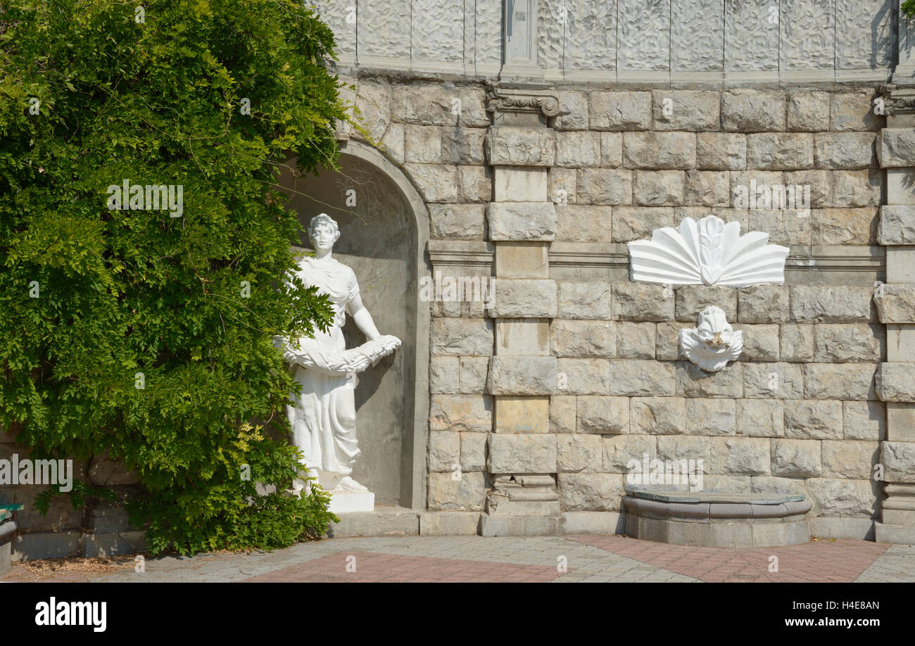 Alten rustiziert Steinmauer mit weißen dekorative Skulptur der Sowjetzeit in öffentlichen Garten. Stockfoto