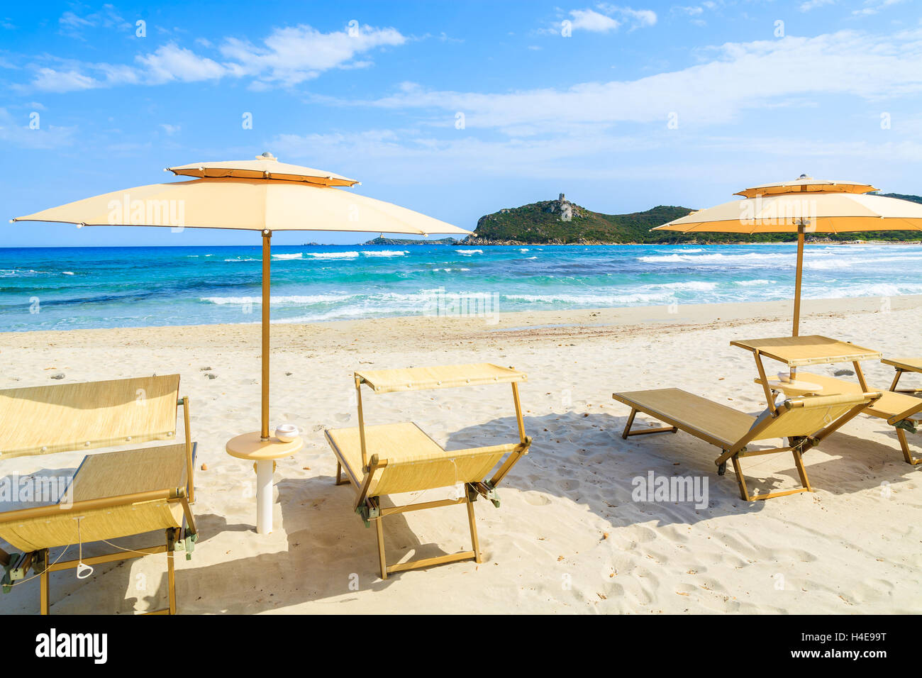 Liegestühle mit Sonnenschirmen am schönen Strand von Porto Giunco, Insel Sardinien, Italien Stockfoto