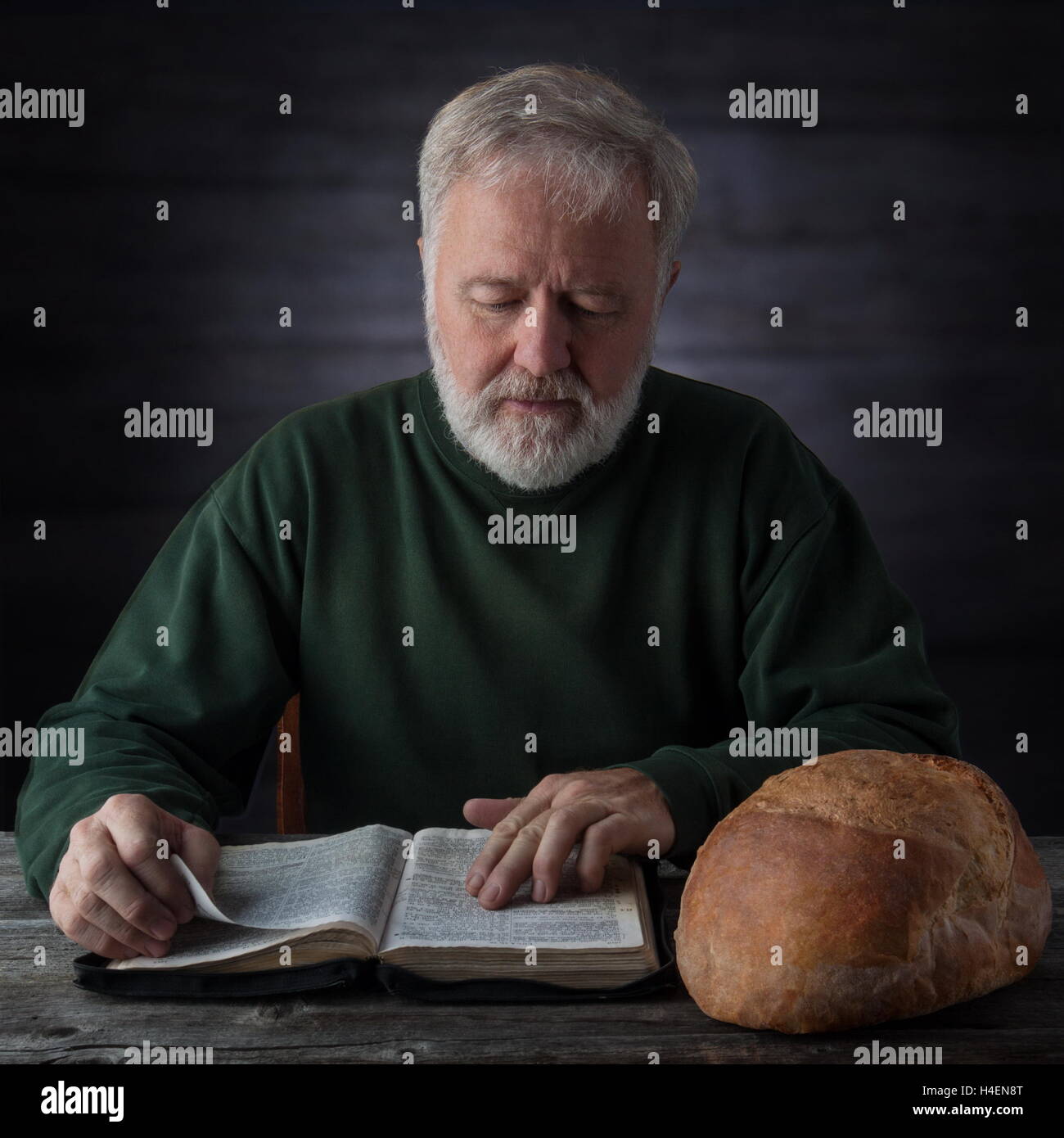 Senior Pastor meditieren und Fütterung auf das Wort Gottes nicht nur durch das tägliche Brot neben ihm. Mat.4.4 der Mensch lebt nicht vom Stockfoto Senior Pastor meditieren und Fütterung auf das Wort Gottes nicht nur durch das tägliche Brot neben ihm. Mat.4.4 der Mensch lebt nicht vom Stockfoto