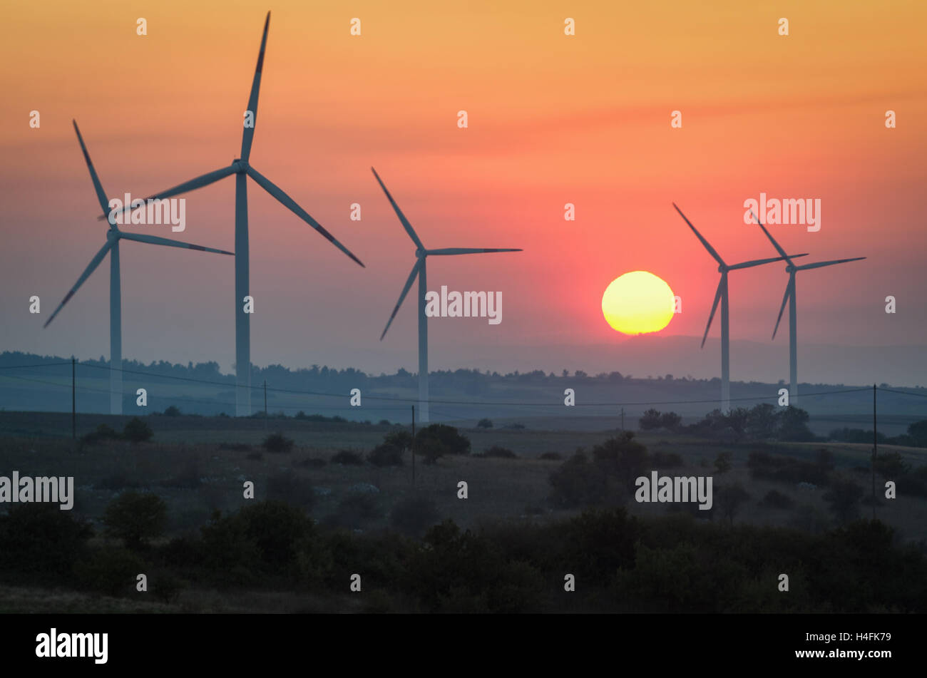 Windenergieanlagen bei Sonnenuntergang - erneuerbare Energie-Konzept Stockfoto