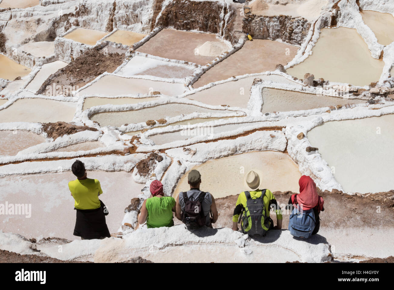 Fünf Touristen Blick auf die Salinen von Maras an einem sonnigen Tag Stockfoto