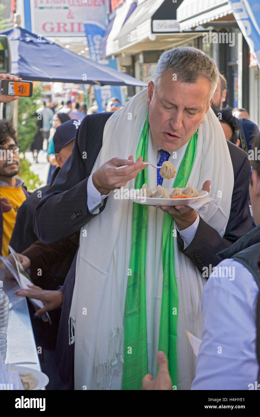 New York City Bürgermeister Bill de Blasio Essen Knödel in Jackson Heights, Queens, New York bei einem Besuch Wählerregistrierung zu fördern. Stockfoto
