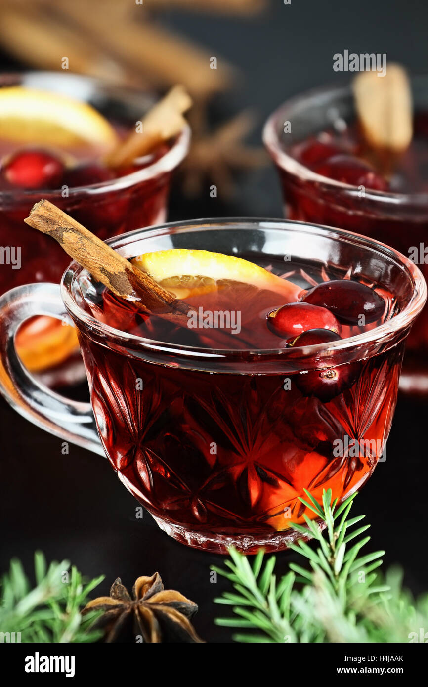 Red Christmas punch / trinken mit Orangenscheiben, Anis, Zimt und frische Cranberries über einem dunklen Hintergrund. Stockfoto