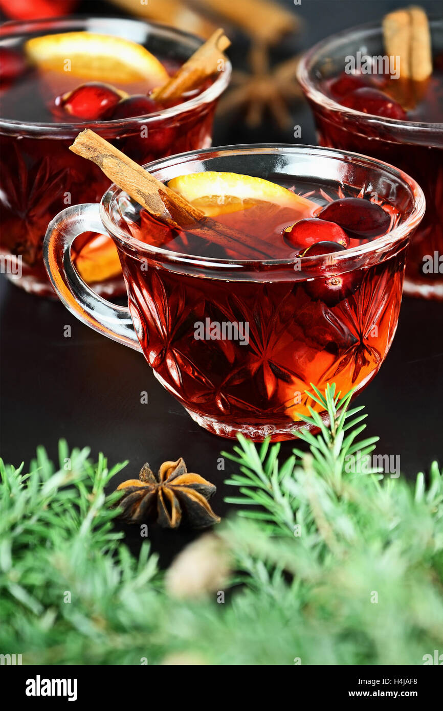 Red Christmas punch / trinken mit Orangenscheiben, Anis, Zimt und frische Cranberries über einem dunklen Hintergrund. Stockfoto