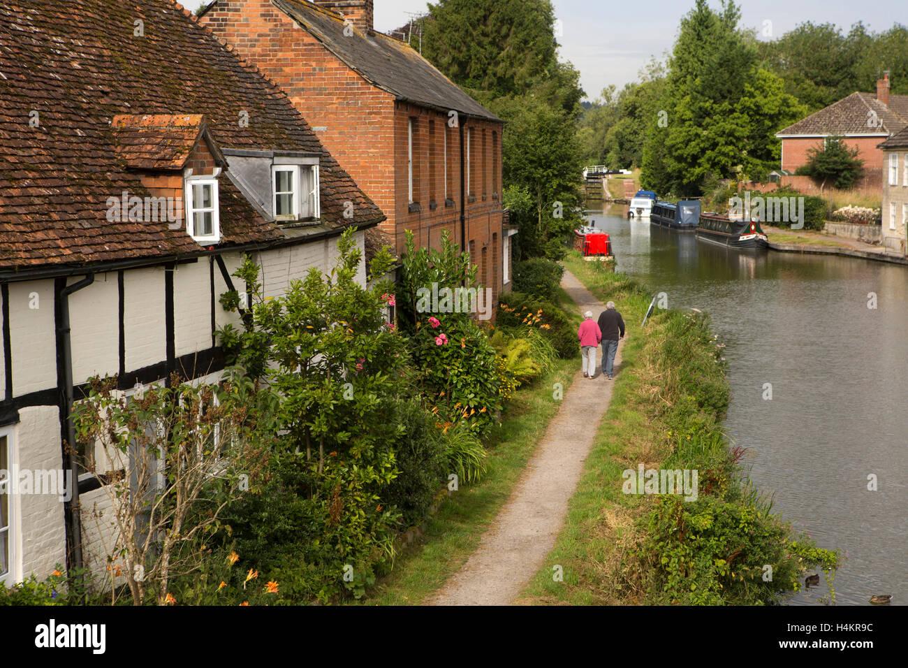 England, Berkshire, Hungerford, älteres Ehepaar, vorbei an alten Häusern am Leinpfad neben Kennet und Avon Kanal Stockfoto