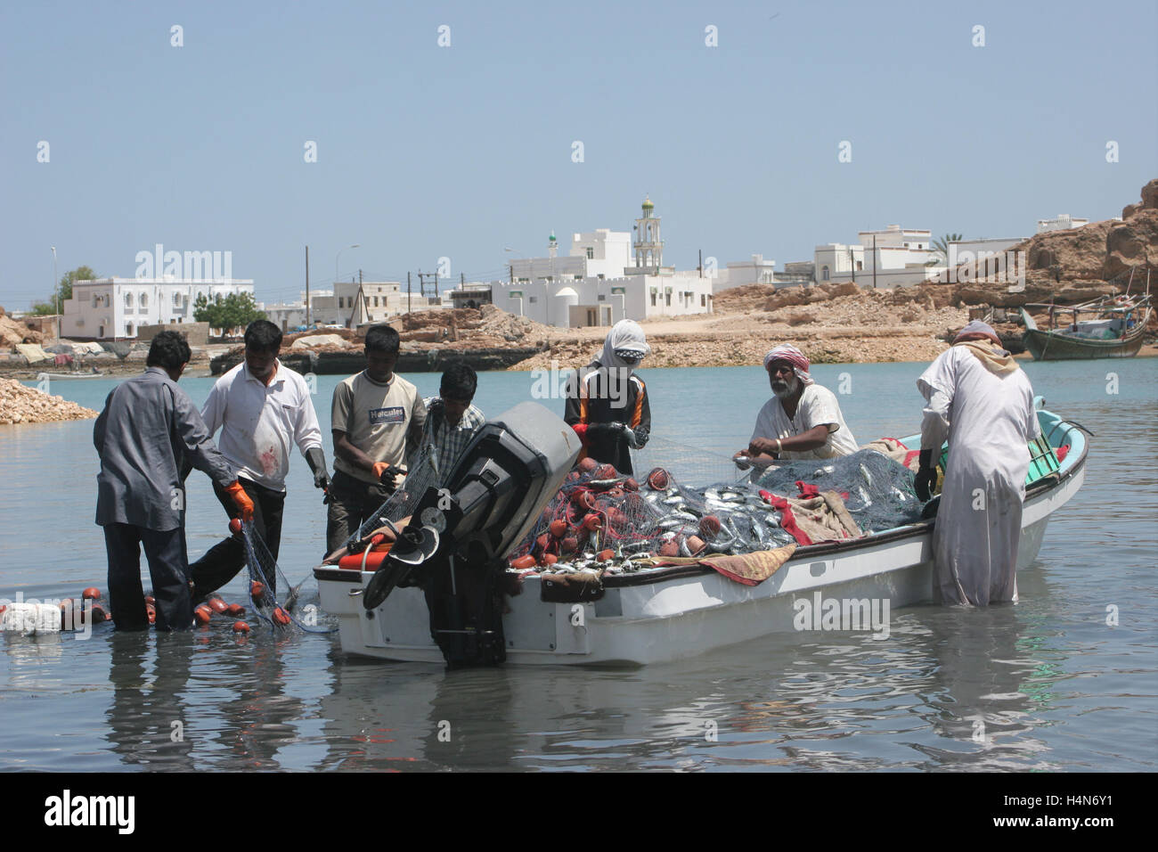 Lokale Fischer entladen ihre kleine Boot sur in Oman Stockfoto