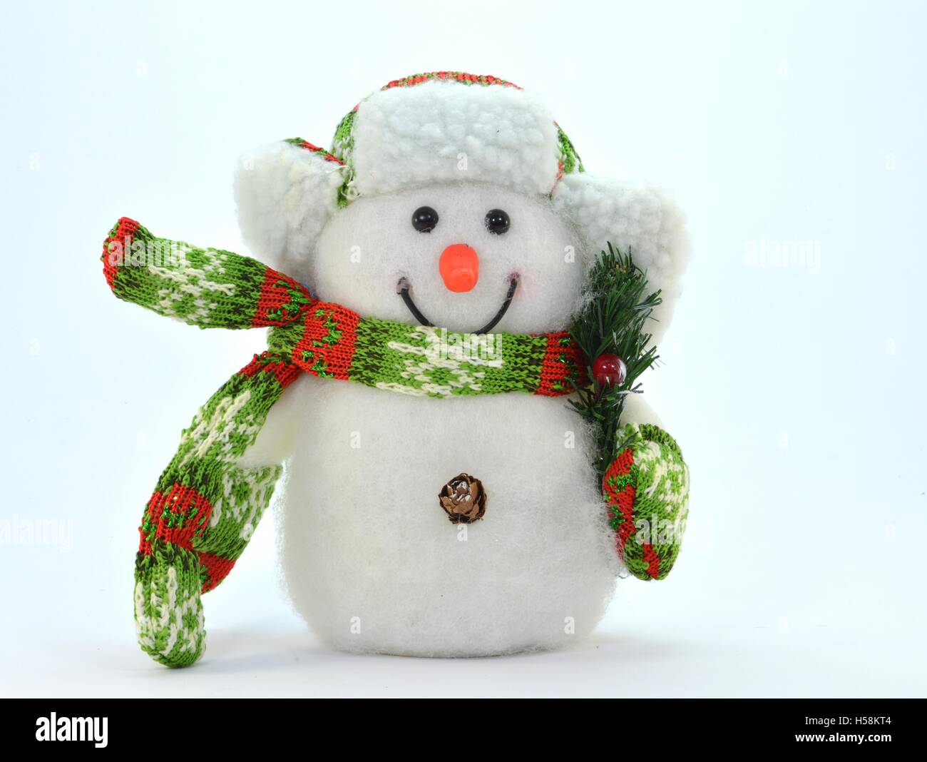 Schneemann mit einem Zweig und einen grünen und roten Schal. Stockfoto