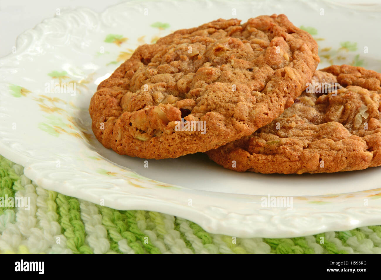 Frisch gebackenes Haferflocken mit Rosinen Walnuss Cookies auf hübschen Vintage Teller im Querformat.  Makro mit selektiven Fokus.  Schuss in na Stockfoto