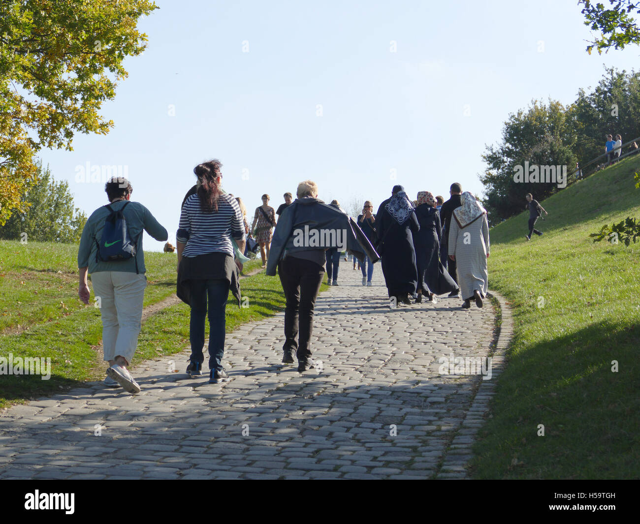 München Olympia Park Fernsehturm Menschen genießen in sonniger Tag Deutschland Europa. Muslimischen Touristen entspannen im Park Stockfoto