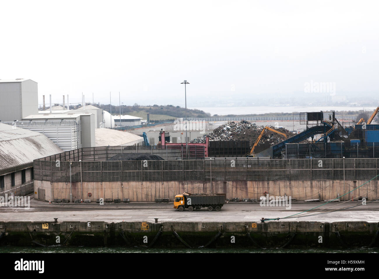 Kipper Lkw vorbeifahren Scrap Yard und industriellen Gebäuden am Kai. Stockfoto