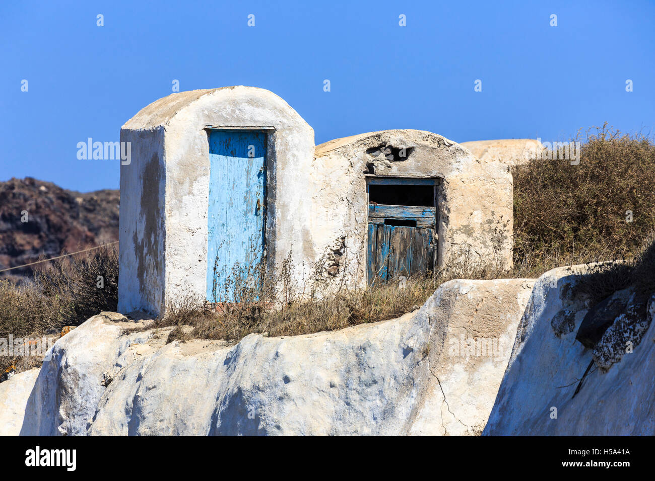 Marode Gebäude mit faulenden Türen und peeling blauen Lackierung in Manolas Dorf auf der Insel Thirassia, Santorin Stockfoto