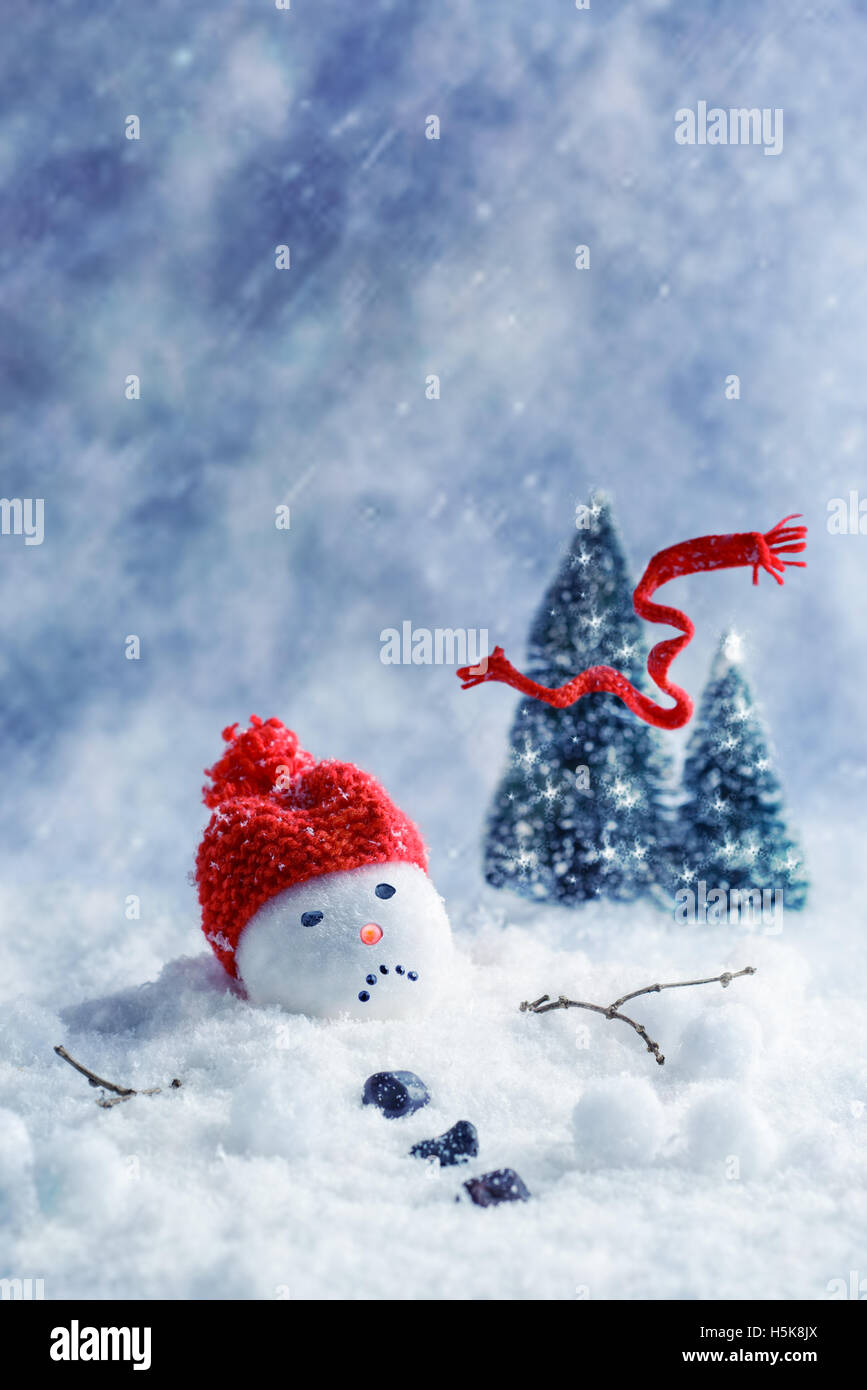 Schneemann mit Schal wegblasen in Weihnachtsbäume schmelzen Stockfoto