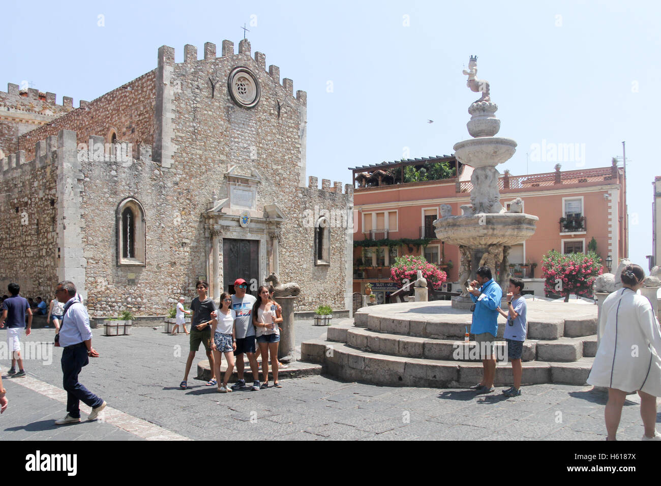 Touristen für Fotos außerhalb des Duomo, Taormina, Sizilien, Italien posing Stockfoto
