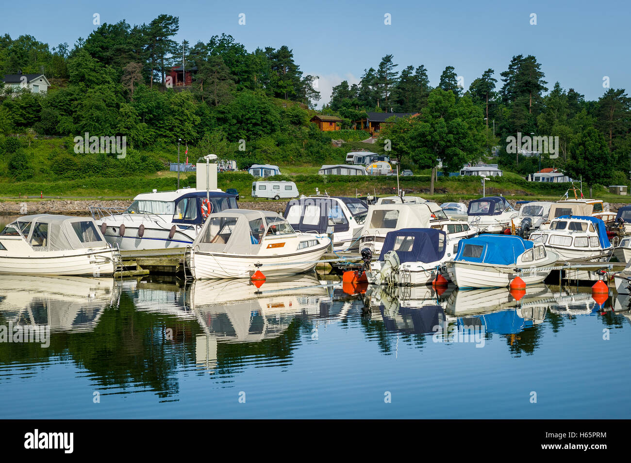 Nordische Fischerboote vertäut am ruhigen Seeufer Stockfoto