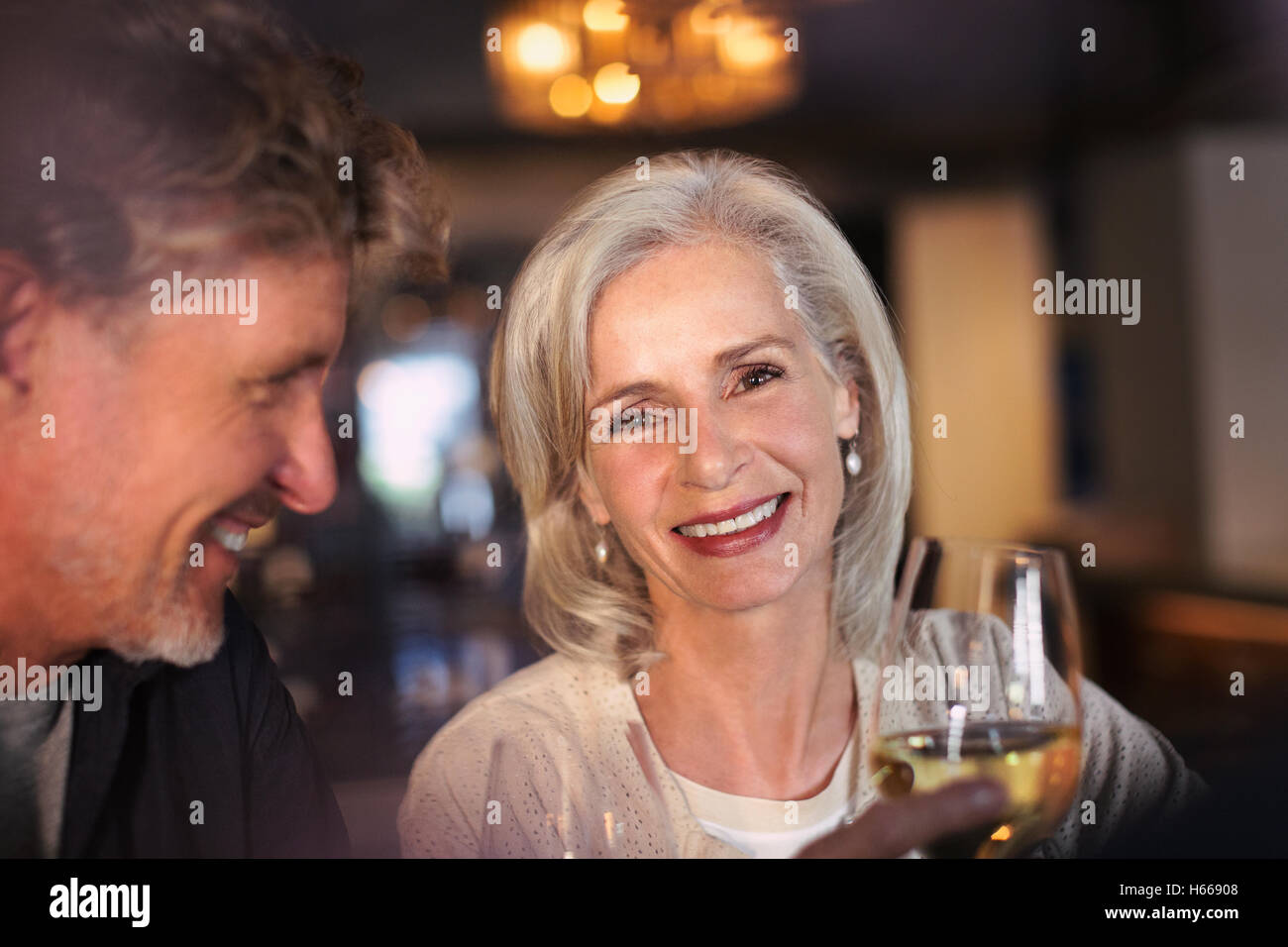Porträt lächelnd älteres paar trinken Weißwein in bar Stockfoto