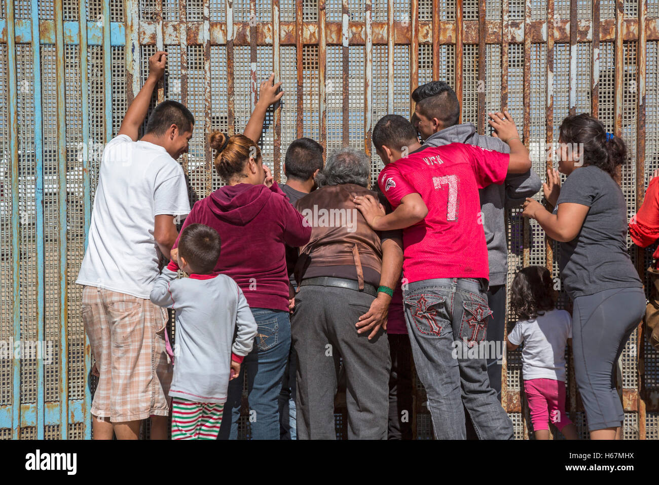 Tijuana, Mexiko - Familienmitglieder, die durch Abschiebung getrennt besuchen durch den US-mexikanischen Grenzzaun. Stockfoto