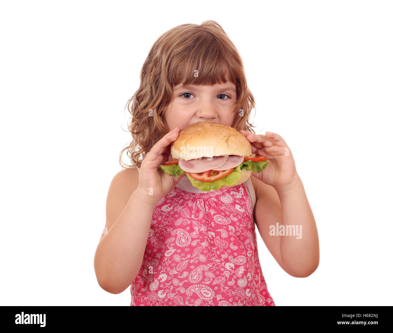 hungriges kleine Mädchen essen große Sandwich auf weiß Stockfoto