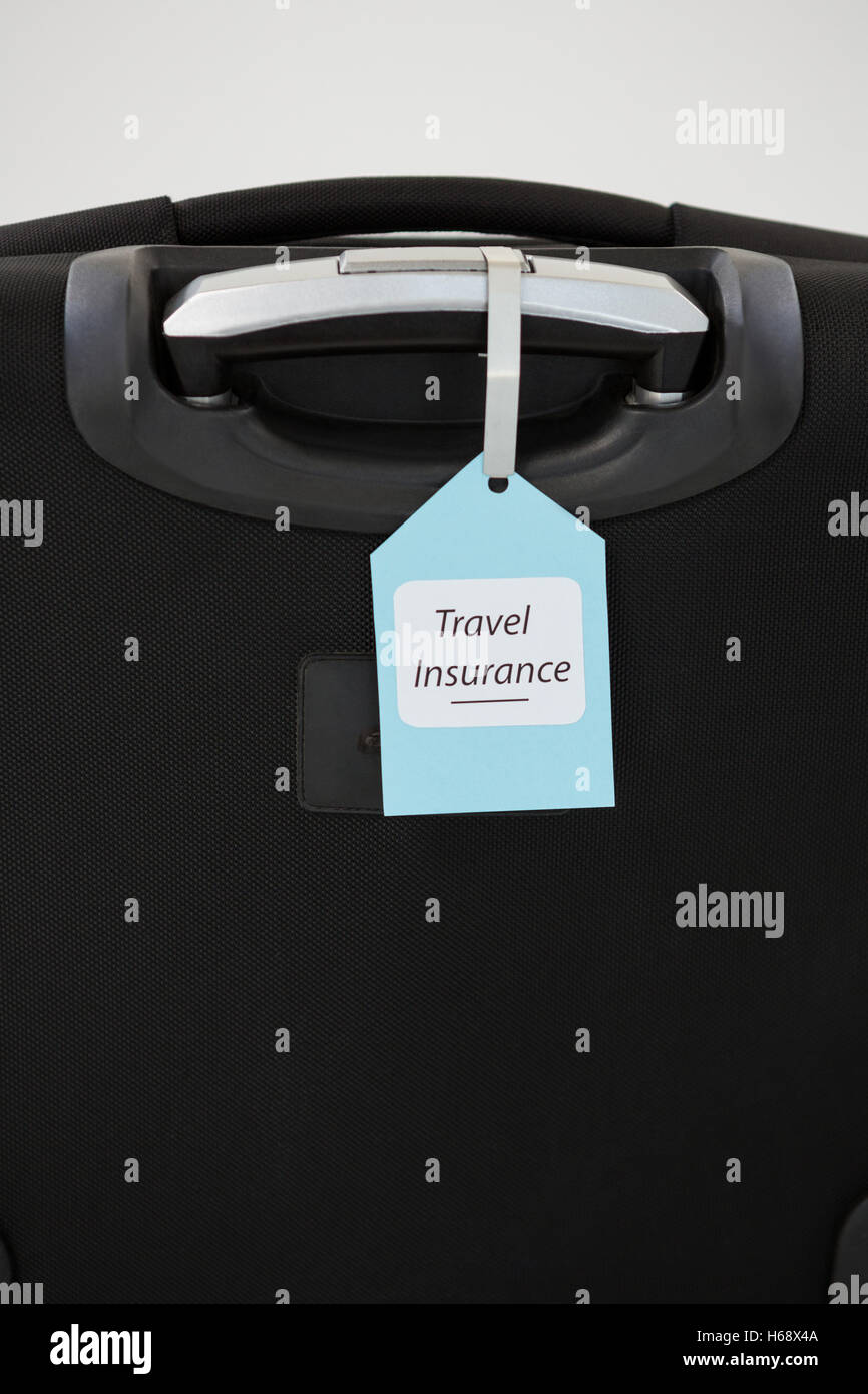 Reise Versicherung Label gebunden an einen Koffer Stockfoto