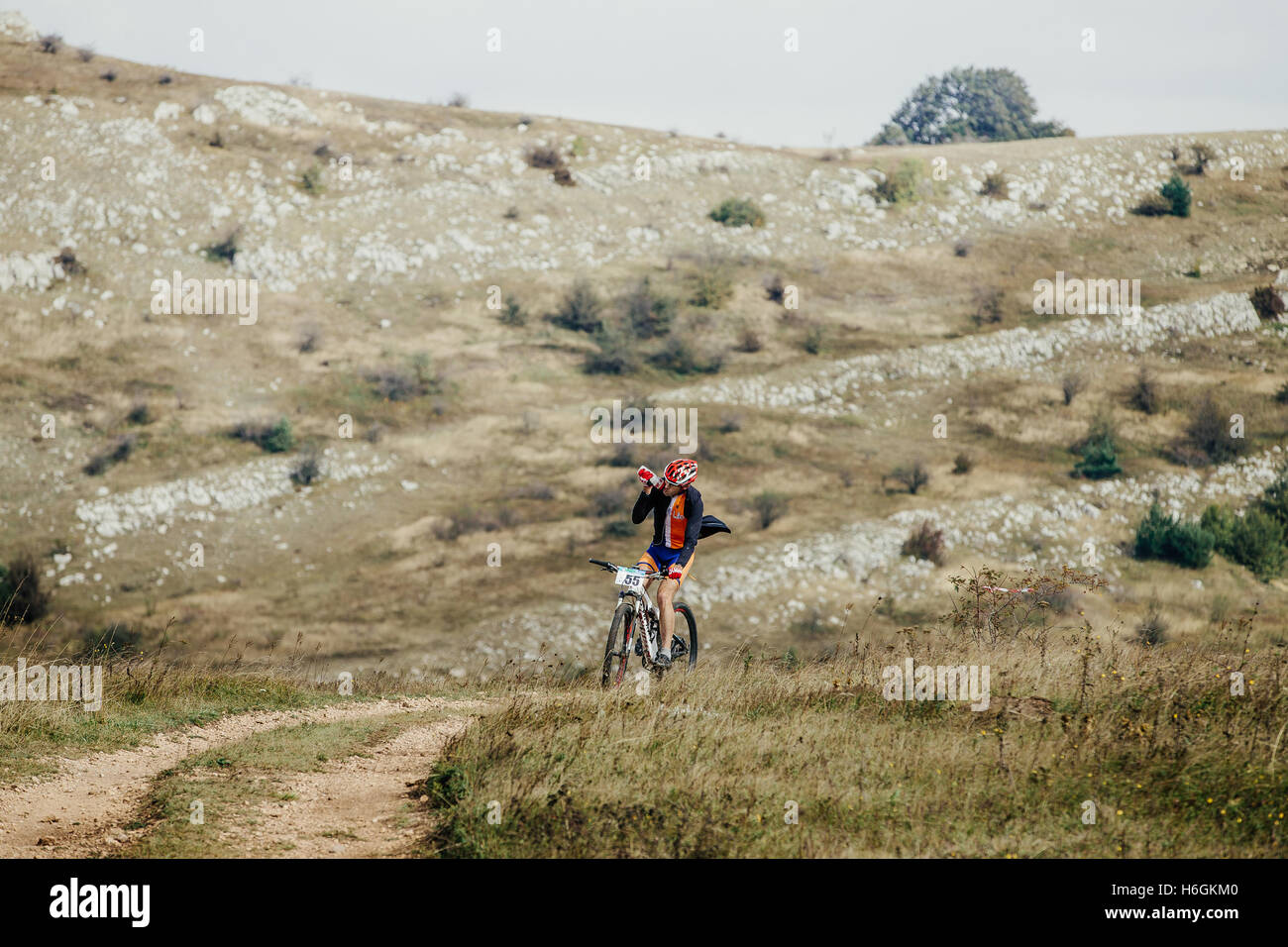 Racer Radfahrer auf das Mountain Bike Trinkwasser aus einer Flasche während der Krim Rennen mountainbike Stockfoto