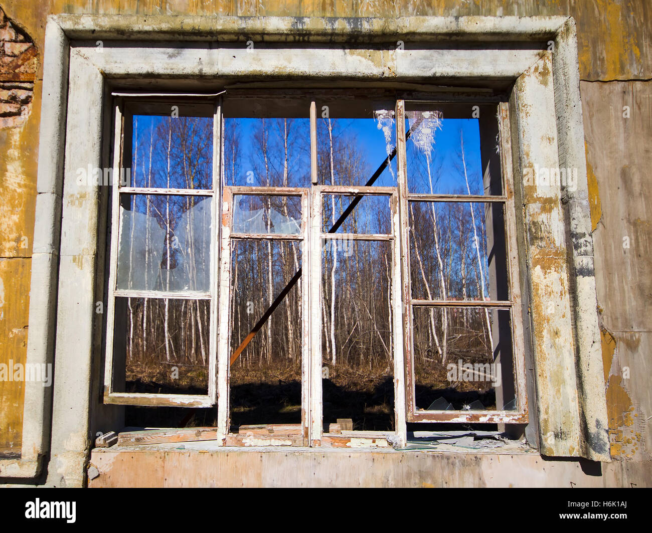 zerbrochenes Fenster in eine Wand aus dem eingestürzten Haus Stockfoto