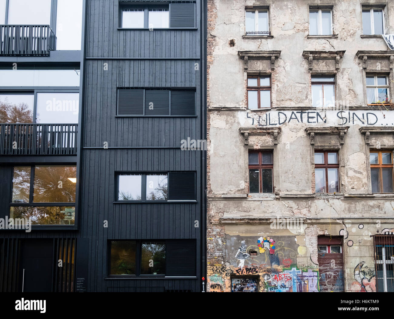 Der Kontrast zwischen moderner Bürogebäude und alten Mietshaus als ein besetztes Haus in Mitte Berlin Deutschland Stockfoto