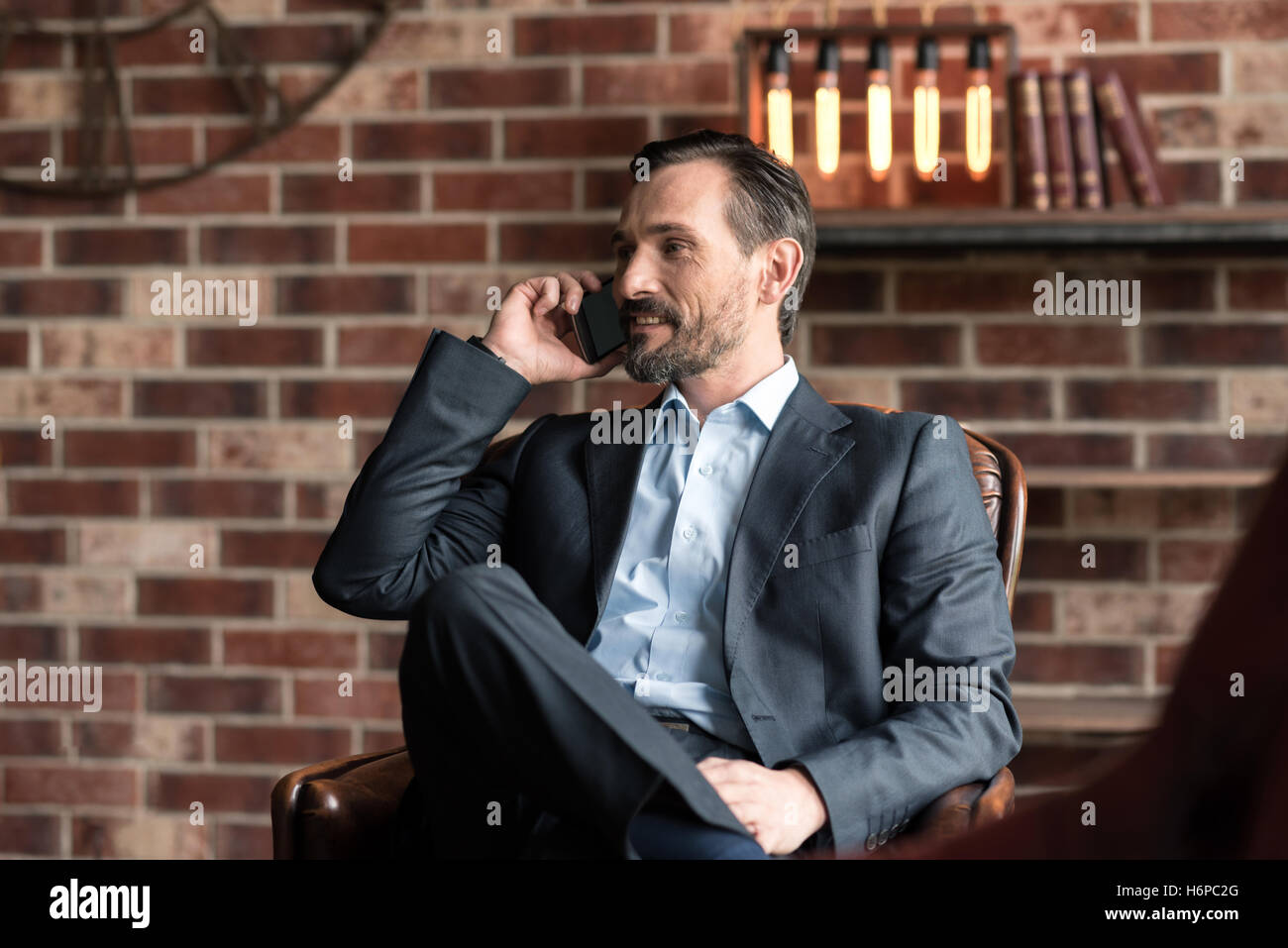 Fröhlich zuversichtlich Geschäftsmann am Telefon sprechen Stockfoto