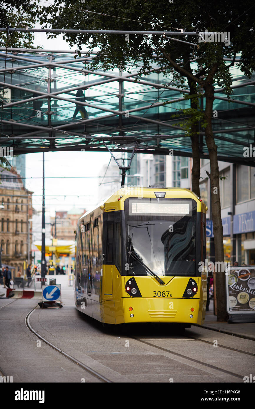 Manchester-Straßenbahn-Wahrzeichen Kreuz Straße Metrolink gelbe gestoppt Glas Gehweg moderne Struktur Tunnel Bombe Lage Overhead wa Stockfoto